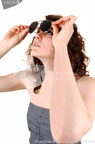 Image of Girl looking trough sunglasses.