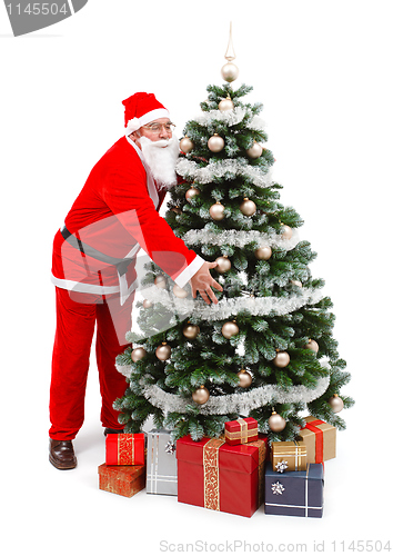 Image of Santa Claus holding Christmas tree