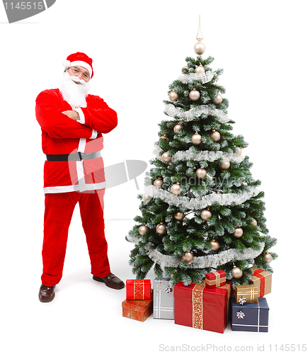 Image of Santa Claus standing near Christmas tree