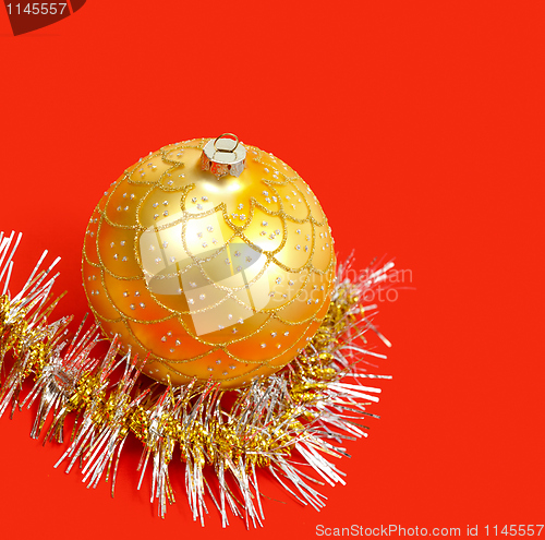 Image of Golden ornament and garland on red