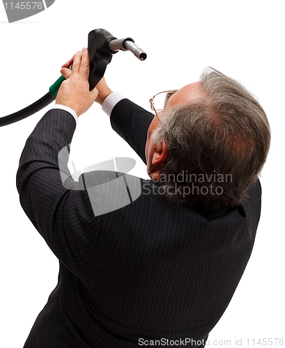 Image of Man looking into gas nozzle