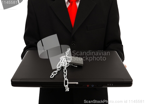 Image of Man holding chained computer
