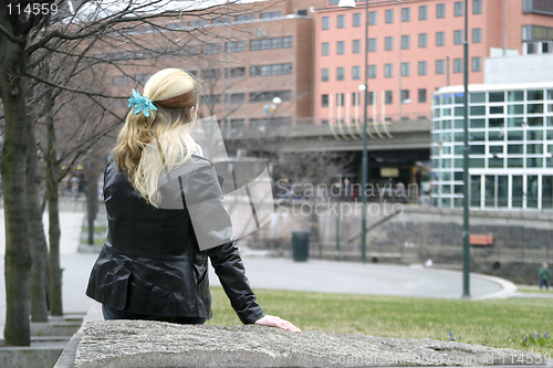 Image of Woman Sitting in City