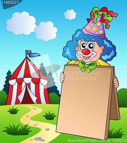 Image of Clown holding board near tent