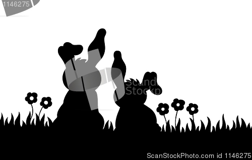 Image of Silhouette of two rabbits on meadow