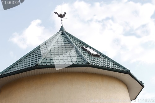 Image of Round tower roof with a weathercock