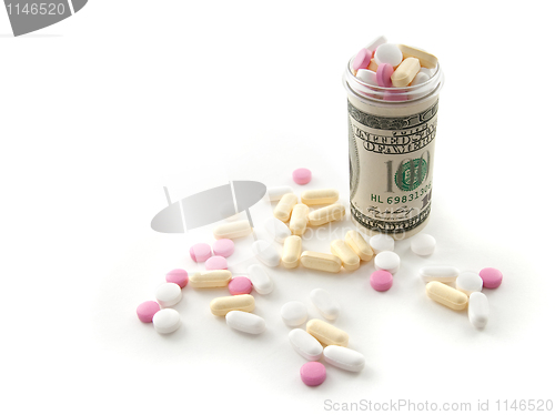 Image of Pills in a bottle made of money