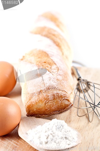 Image of bread, flour, eggs and kitchen utensil