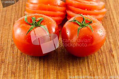 Image of Two tomatoes on a wooden board 