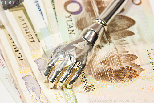 Image of Iron hand watching money