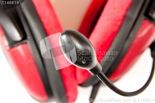 Image of Microphone with headset in the background