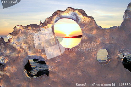 Image of Sunset through ice's holes