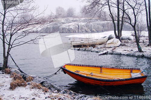Image of Orange fishing boat in winter in Finland