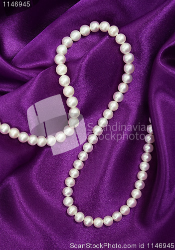Image of White pearls on a lilac silk 