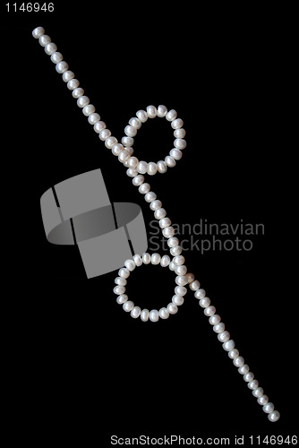 Image of White pearls on the black velvet background 