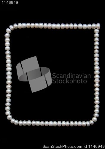 Image of White pearls on the black velvet background 