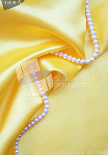 Image of Smooth elegant golden silk with pearls 