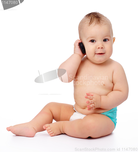 Image of Cute little baby is talking on cell phone