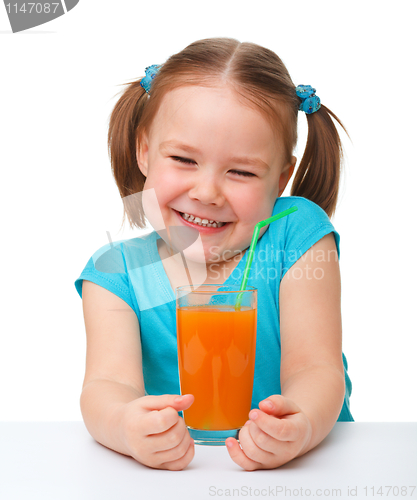 Image of Happy little girl with orange juice