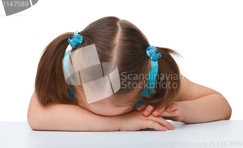 Image of Little girl is sleeping at table