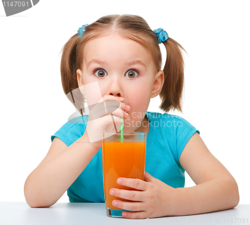 Image of Little girl drinks orange juice