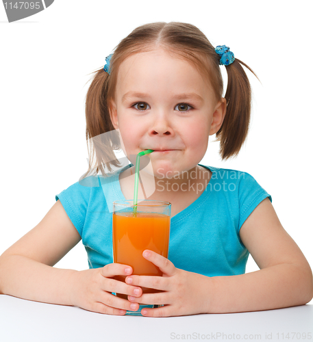 Image of Little girl drinks orange juice