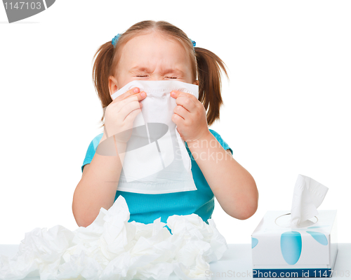 Image of Little girl blows her nose