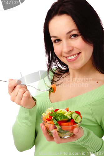 Image of Young attractive woman eats vegetable salad
