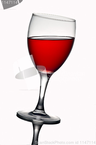 Image of Leaning wine glass with red wine 