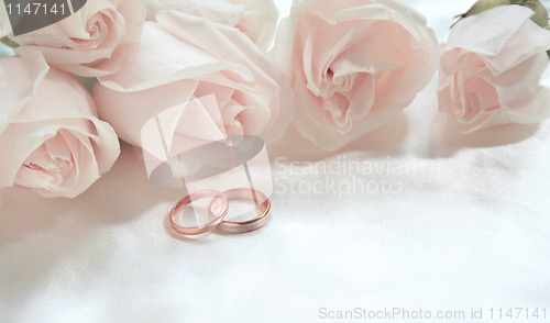 Image of Wedding rings and roses as background 