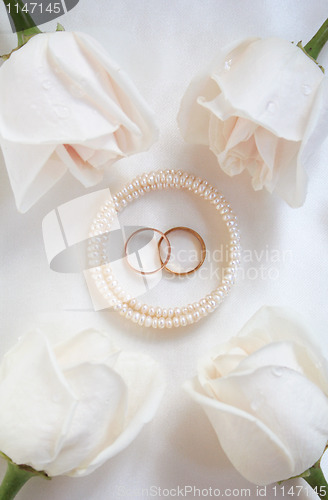 Image of Wedding rings and roses as background 