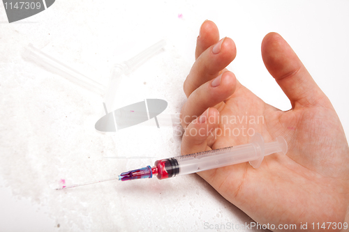 Image of Syringe in a palm of the addict