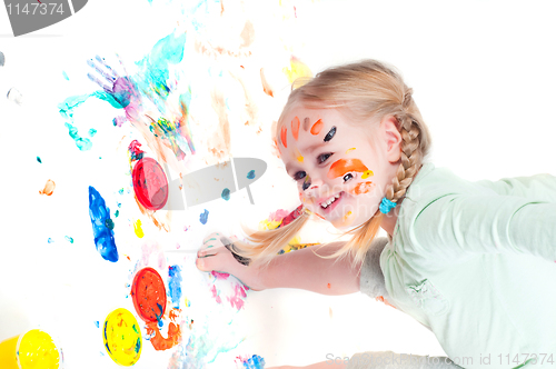 Image of Little girl playing with colors