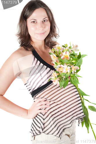 Image of Portrait of pretty pregnant woman with flowers