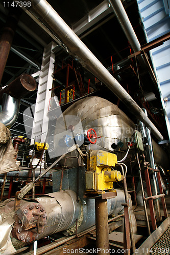 Image of different size and shaped pipes and valves at a power plant 