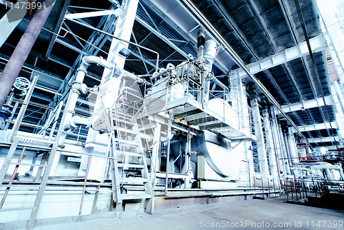 Image of different size and shaped pipes and valves at a power plant 