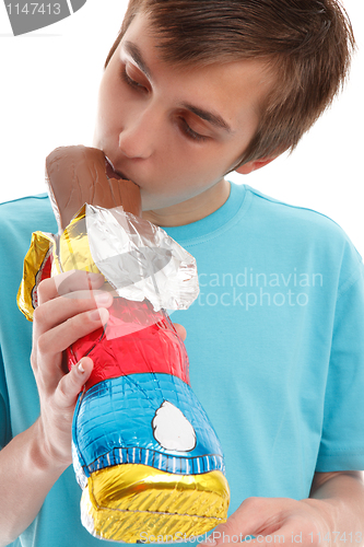 Image of Boy biting ear of chocolate rabbit