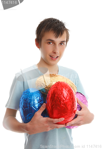 Image of Boy holding 4 large easter eggs