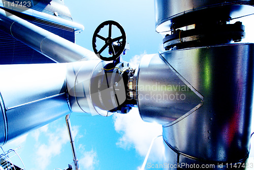 Image of Industrial zone, Steel pipelines and valves against blue sky