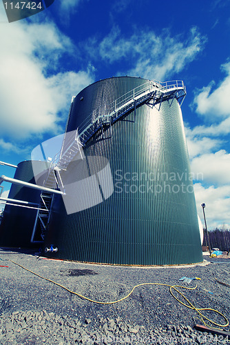 Image of Industrial zone, Steel pipelines and tanks against blue sky