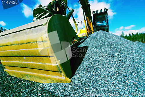 Image of excavator against blue sky    