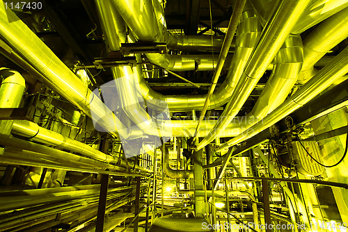 Image of Industrial zone, Steel pipelines in yellow tones  