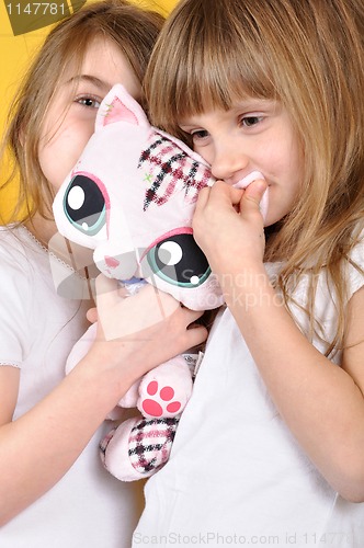 Image of children with a toy plush cat