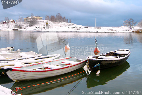 Image of Boats Under Snow In Finland