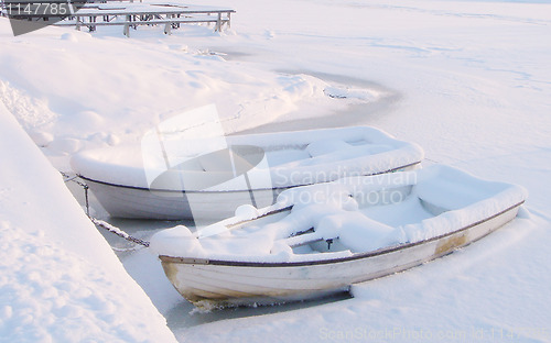 Image of Winter Boats Under Snow In Finland           