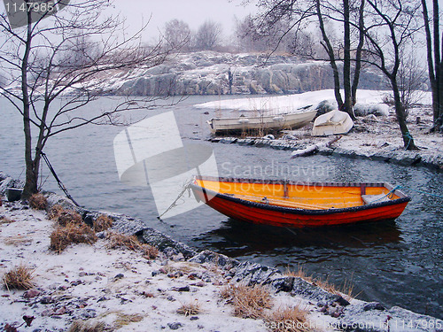 Image of Orange fishing boat in winter in Finland