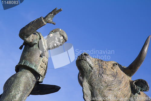 Image of Sculpture of a bullfighter in front of his fight bull