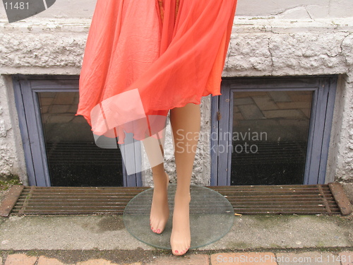 Image of Mannequin doll outside shop. The wind blowing her skirt.