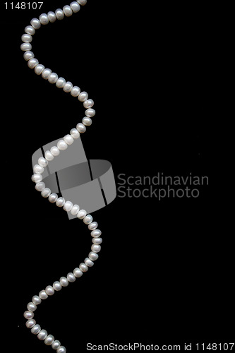 Image of White pearls on the black silk 