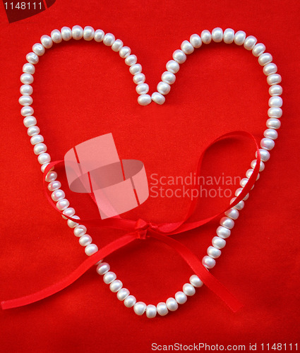 Image of Heart from white pearls on a red silk for St Valentine's day 